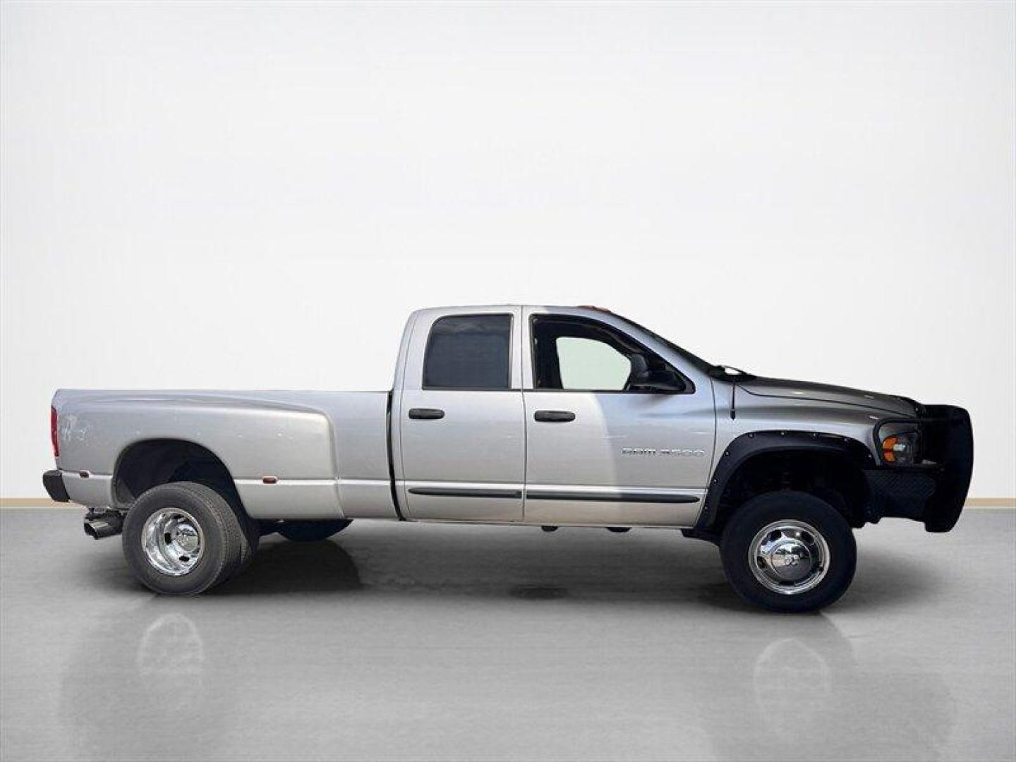 2003 Bright Silver Metallic Clearcoat /Charcoal Dodge Ram 3500 SLT DRW (3D7MU48C23G) with an Cummins 5.9L Diesel Turbo I6 305hp 555ft. lbs. engine, Automatic transmission, located at 25355 Eames Street, Channahon, IL, 60410, (815) 467-1807, 41.429108, -88.228432 - Behold the majestic 2003 Dodge Ram 3500 Quad Cab SLT, a true titan of the road! Powered by the legendary Cummins 5.9L Diesel Turbo I6 engine, this beast roars with 305hp and a jaw-dropping 555ft. lbs. of torque, ready to conquer any challenge that comes its way. Cloaked in a regal Bright Silver Met - Photo#1
