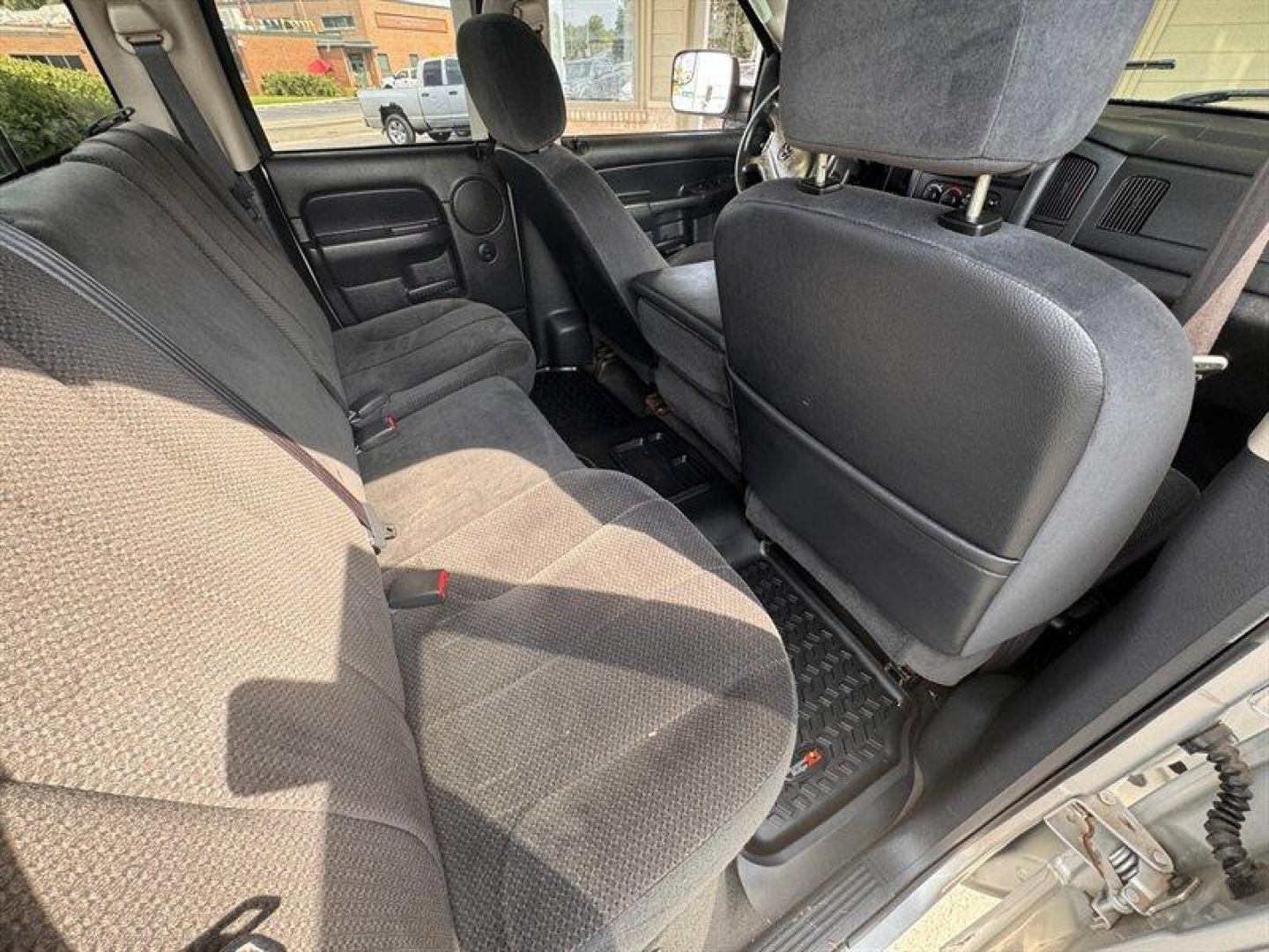 2003 Bright Silver Metallic Clearcoat /Charcoal Dodge Ram 3500 SLT DRW (3D7MU48C23G) with an Cummins 5.9L Diesel Turbo I6 305hp 555ft. lbs. engine, Automatic transmission, located at 25355 Eames Street, Channahon, IL, 60410, (815) 467-1807, 41.429108, -88.228432 - Behold the majestic 2003 Dodge Ram 3500 Quad Cab SLT, a true titan of the road! Powered by the legendary Cummins 5.9L Diesel Turbo I6 engine, this beast roars with 305hp and a jaw-dropping 555ft. lbs. of torque, ready to conquer any challenge that comes its way. Cloaked in a regal Bright Silver Met - Photo#14