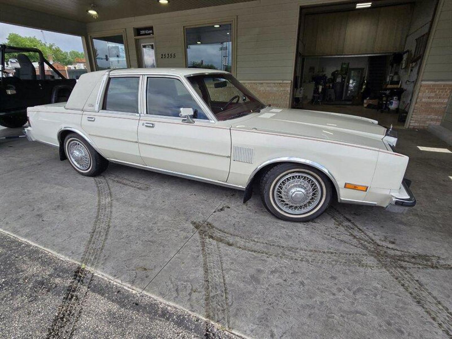 1984 White Chrysler Fifth Avenue (1C3BF66P0EX) with an 5.2L V8 130hp 235ft. lbs. engine, Automatic transmission, located at 25355 Eames Street, Channahon, IL, 60410, (815) 467-1807, 41.429108, -88.228432 - Step back in time with this vintage 1984 Chrysler Fifth Avenue that's as sassy as they come! Powered by a 5.2L V8 engine pumping out 130hp and 235ft. lbs. of torque, this classic beauty is ready to hit the streets with style. Decked out in a sleek White exterior and a bold Red interior, this Fifth - Photo#1