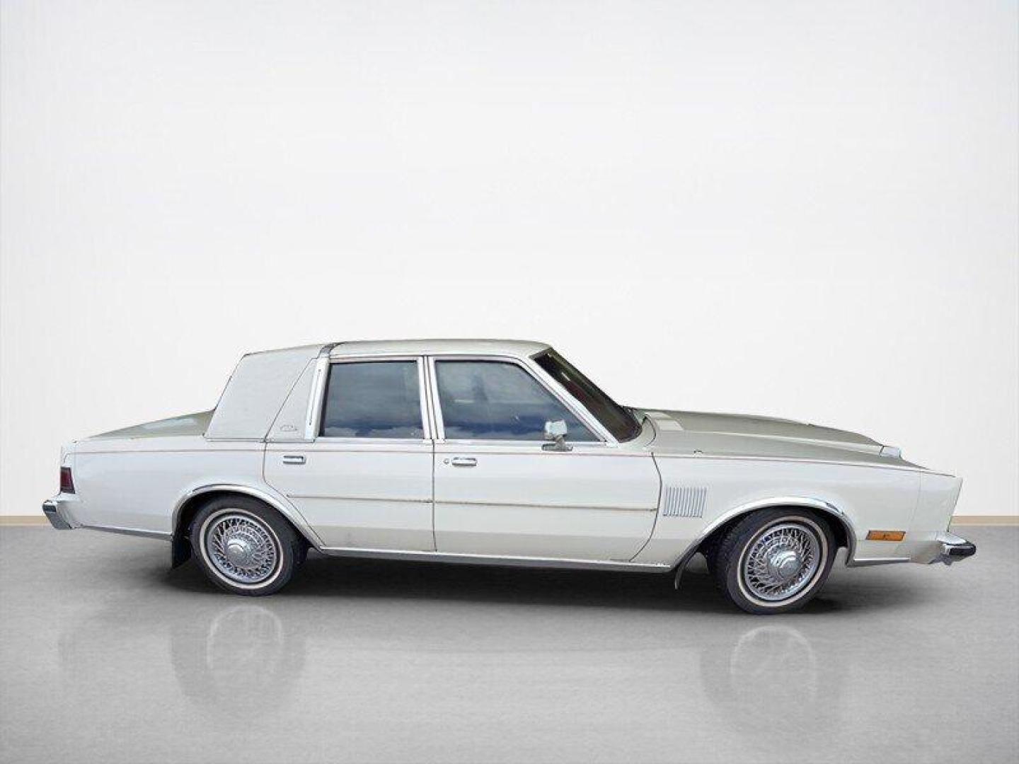 1984 White Chrysler Fifth Avenue (1C3BF66P0EX) with an 5.2L V8 130hp 235ft. lbs. engine, Automatic transmission, located at 25355 Eames Street, Channahon, IL, 60410, (815) 467-1807, 41.429108, -88.228432 - Step back in time with this vintage 1984 Chrysler Fifth Avenue that's as sassy as they come! Powered by a 5.2L V8 engine pumping out 130hp and 235ft. lbs. of torque, this classic beauty is ready to hit the streets with style. Decked out in a sleek White exterior and a bold Red interior, this Fifth - Photo#2