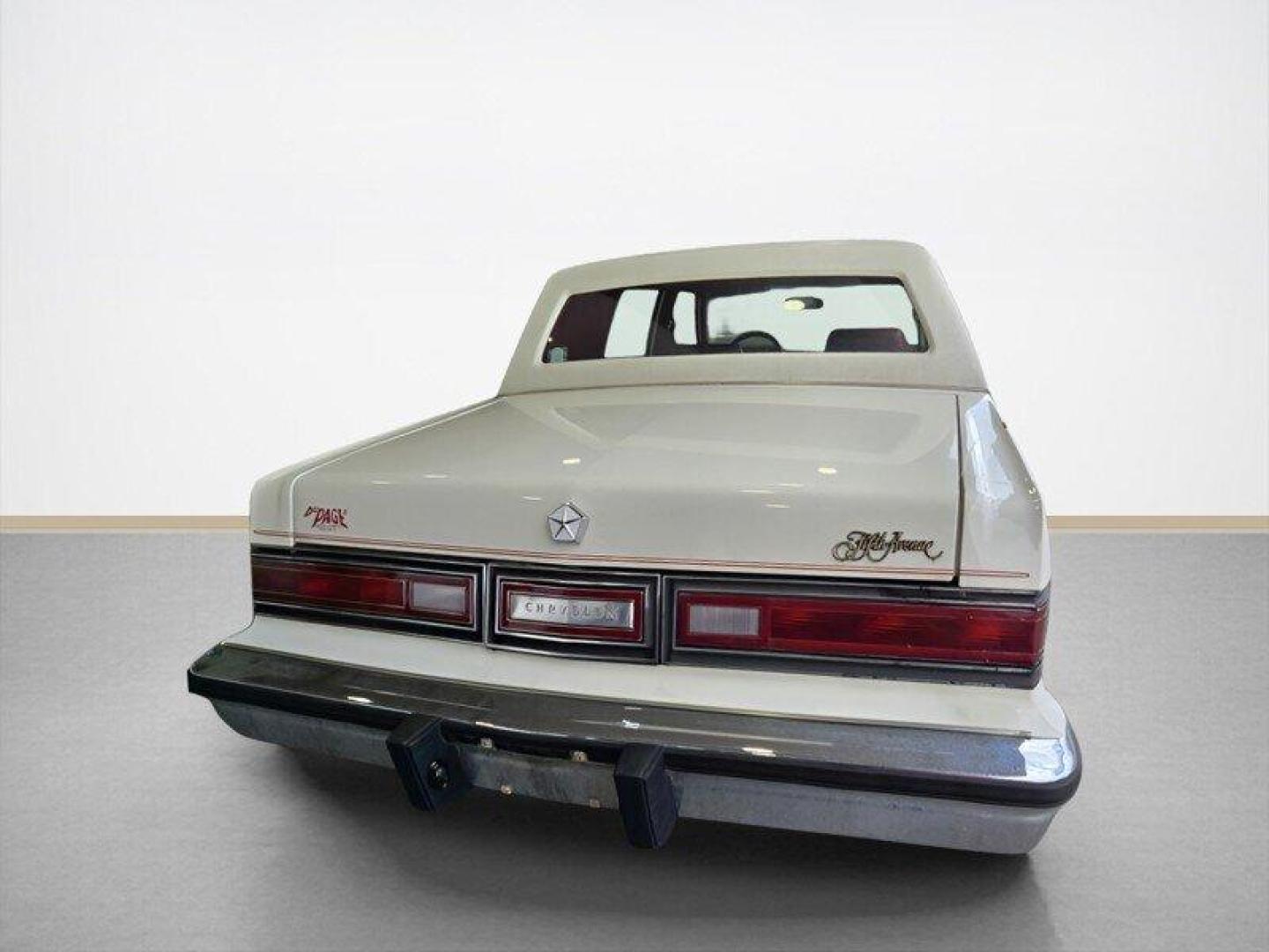 1984 White Chrysler Fifth Avenue (1C3BF66P0EX) with an 5.2L V8 130hp 235ft. lbs. engine, Automatic transmission, located at 25355 Eames Street, Channahon, IL, 60410, (815) 467-1807, 41.429108, -88.228432 - Step back in time with this vintage 1984 Chrysler Fifth Avenue that's as sassy as they come! Powered by a 5.2L V8 engine pumping out 130hp and 235ft. lbs. of torque, this classic beauty is ready to hit the streets with style. Decked out in a sleek White exterior and a bold Red interior, this Fifth - Photo#5