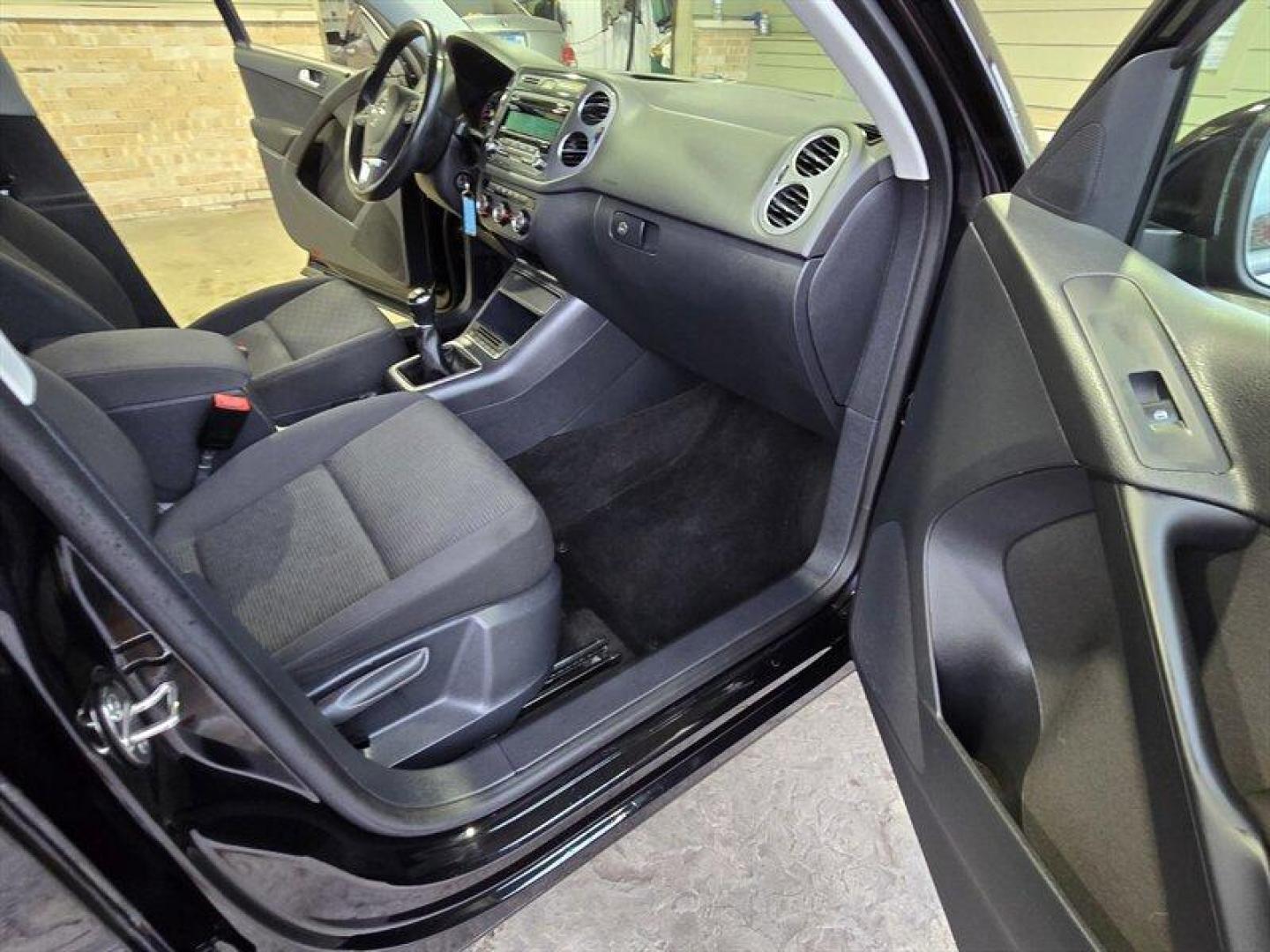 2014 Deep Black Metallic Volkswagen Tiguan S (WVGCV3AXXEW) with an 2.0L Turbo I4 200hp 207ft. lbs. engine, 6 Speed Manual transmission, located at 25355 Eames Street, Channahon, IL, 60410, (815) 467-1807, 41.429108, -88.228432 - ** HARD TO FIND 6-SPEED MANUAL ** 2014 Volkswagen Tiguan S Deep Black Metallic exterior with Black cloth interior. Powered by a 2.0L turbocharged inline-4 producing 200 hp and 207 lb-ft of torque, this Tiguan delivers confident acceleration and everyday driving flexibility. It has under 92,000 mile - Photo#24